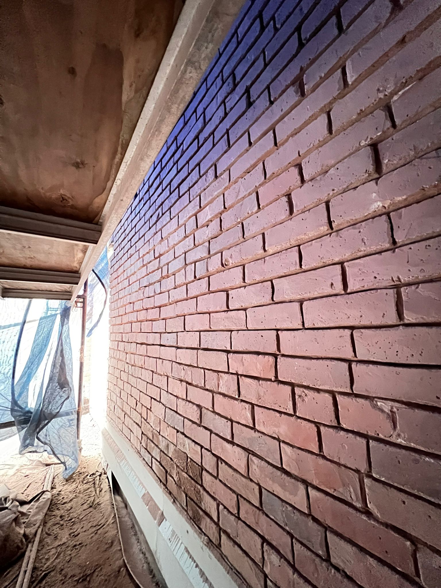Re-pointed heritage brick interior wall — The Keefer