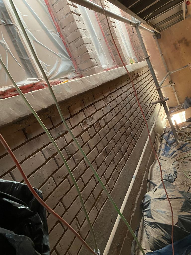 Interior brick veneer installation beneath window line — The Keefer