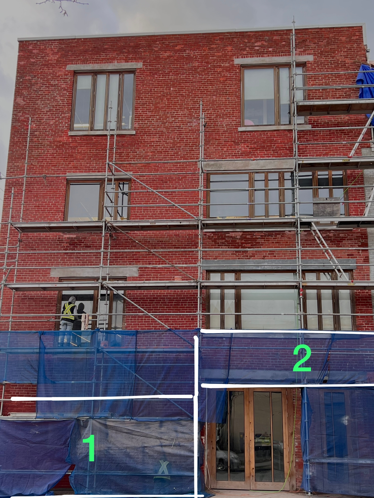Facade sections marked for restoration sequencing — Living Spaces