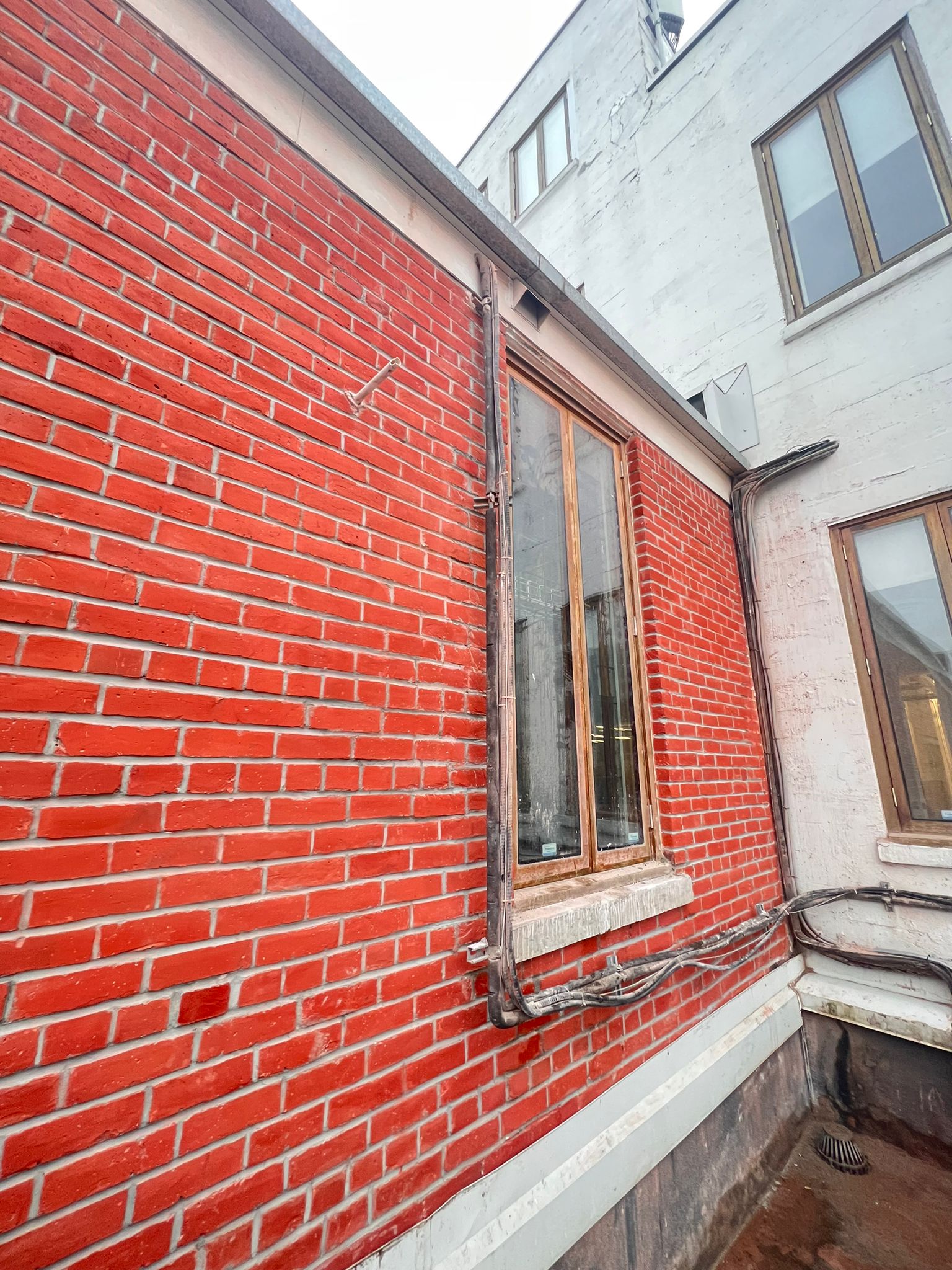 Rooftop brick corner with window detail — Living Spaces