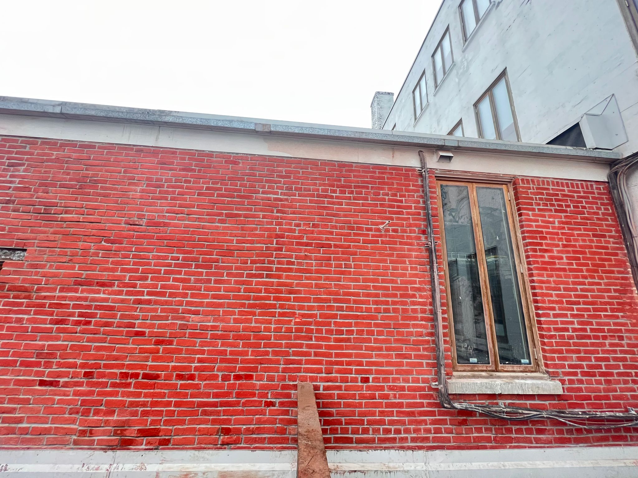Rooftop brick facade beside French doors — Living Spaces