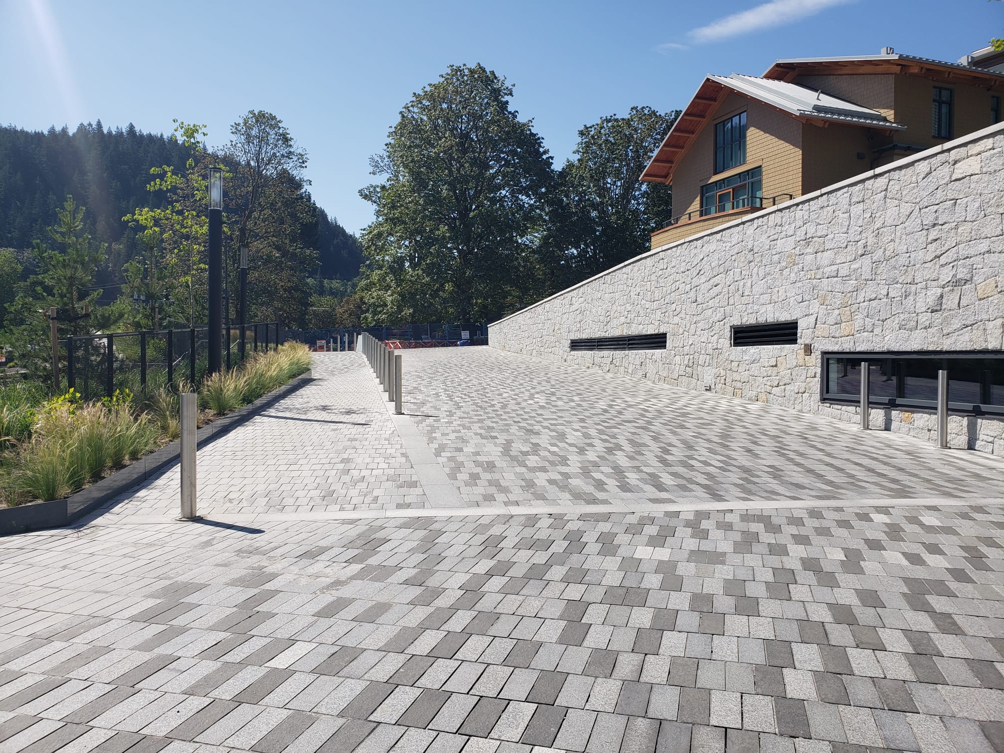 Paver plaza beside stone retaining wall at Sewell's Landing