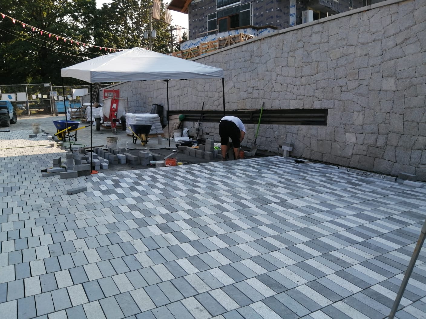 Paver installation beneath feature wall — Sewell's Landing